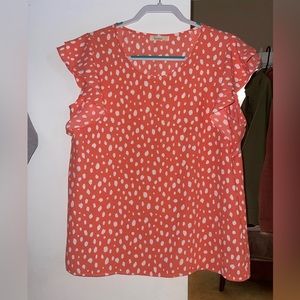 Coral colored thin blouse with white dot details